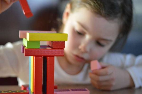 a child playing with colorful blocks