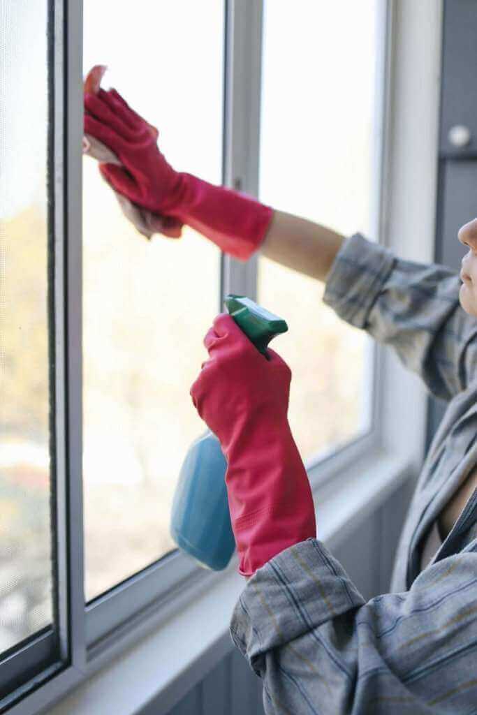 Two professional cleaners deep cleaning a kitchen in a Lambeth flat.