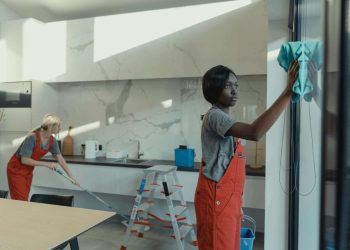 Professional cleaners working in a kitchen during a check-out cleaning service in Wanstead.